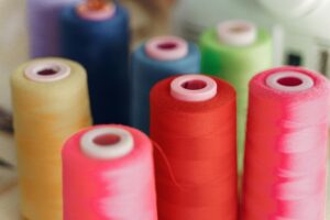 Vibrant spools of sewing thread for arts and crafts projects, ideal for sewing enthusiasts.